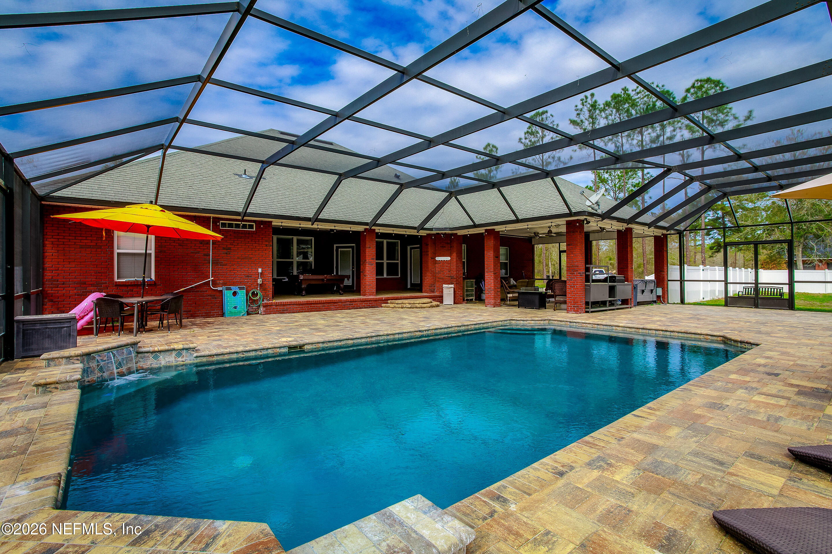 3795 Raintree Drive Macclenny, FL 32063 - Photo 23 of 40 a view of a swimming pool with a patio