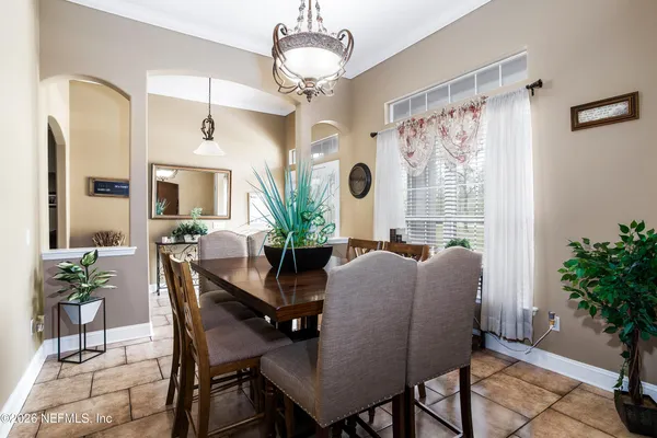 a view of a dining room with furniture and a potted plant
