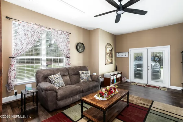 a living room with furniture and wooden floor