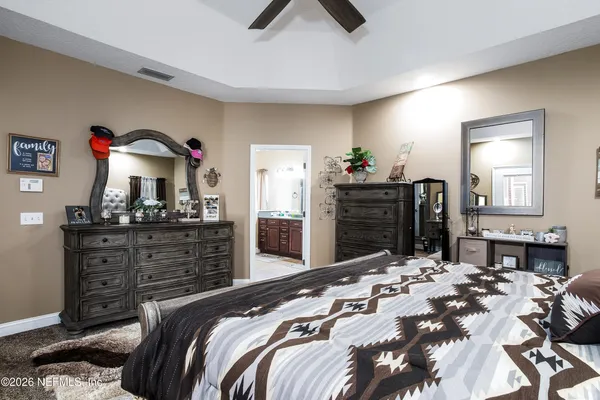 a bedroom with a bed and a dresser