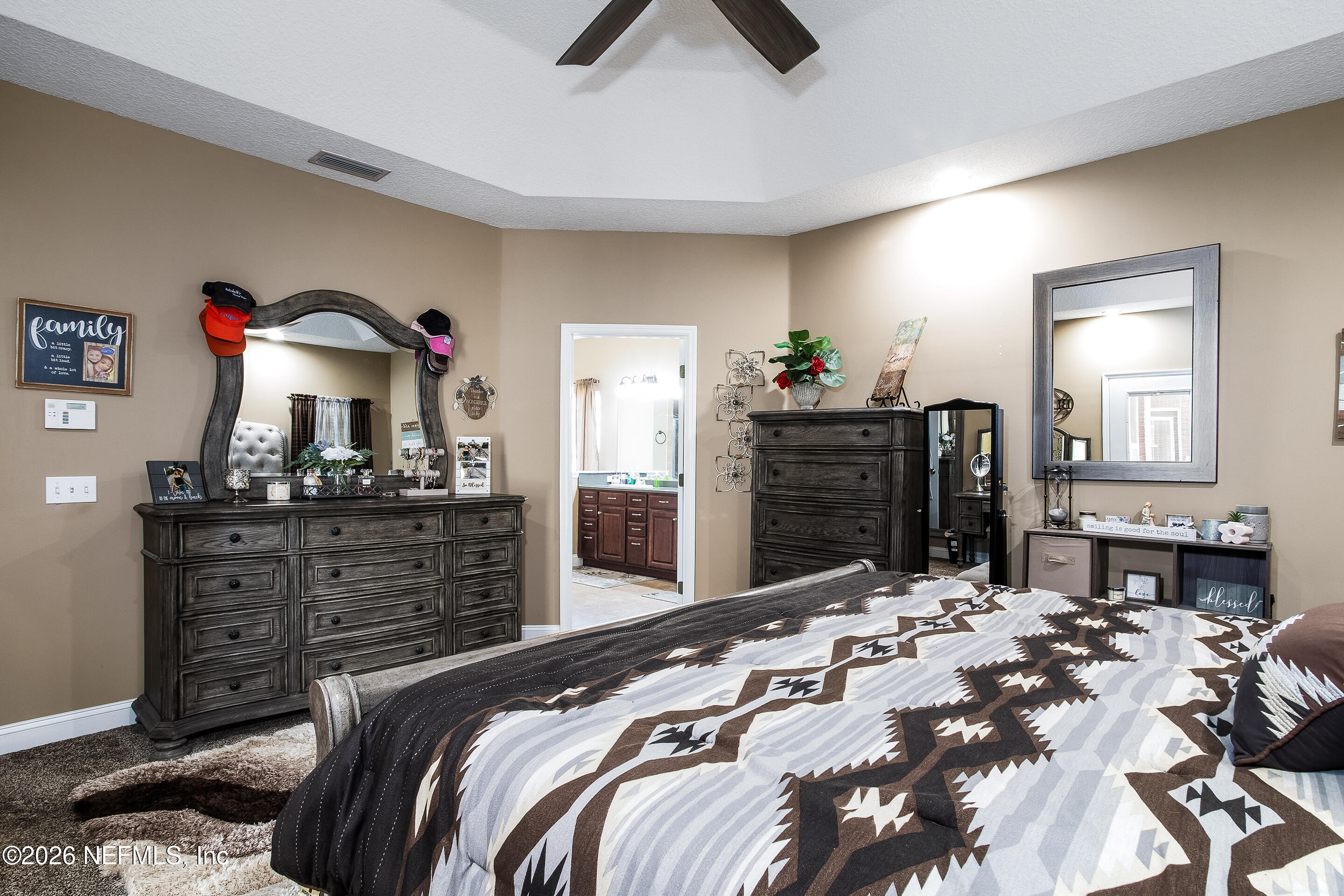 3795 Raintree Drive Macclenny, FL 32063 - Photo 9 of 40 a bedroom with a bed and a dresser