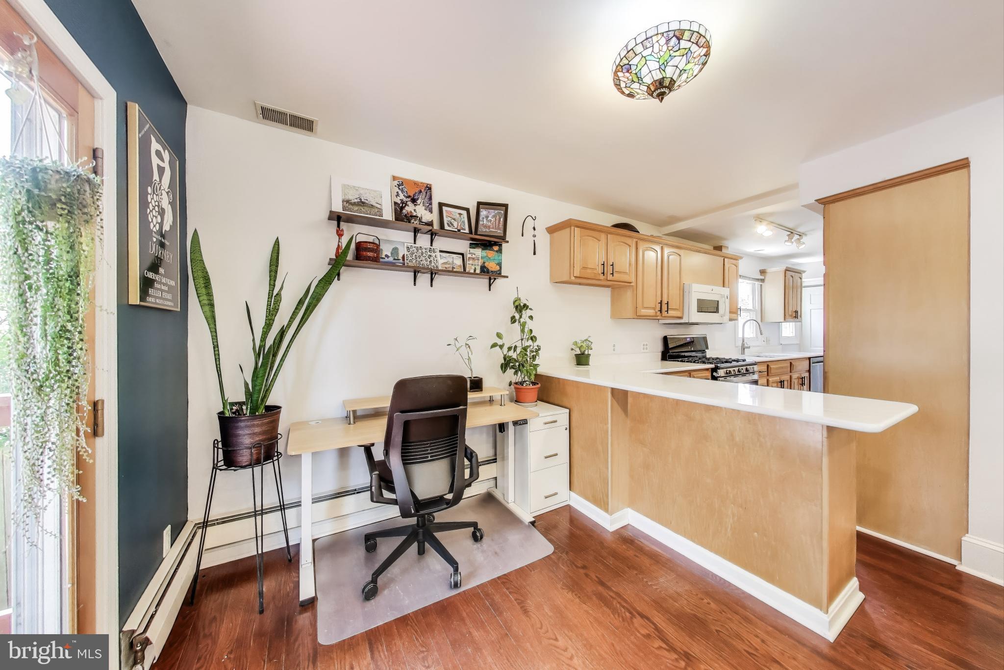 805 Islington Street Silver Spring, MD 20910 - Photo 14 of 50 a view of a workspace with furniture and a potted plant