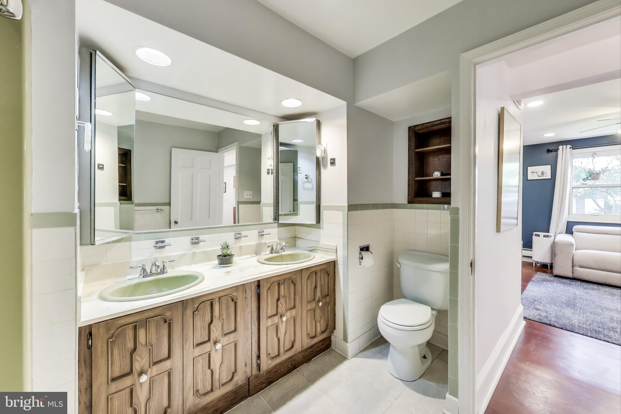 805 Islington Street Silver Spring, MD 20910 - Photo 21 of 50 a spacious bathroom with a toilet sink a mirror a shower and vanity
