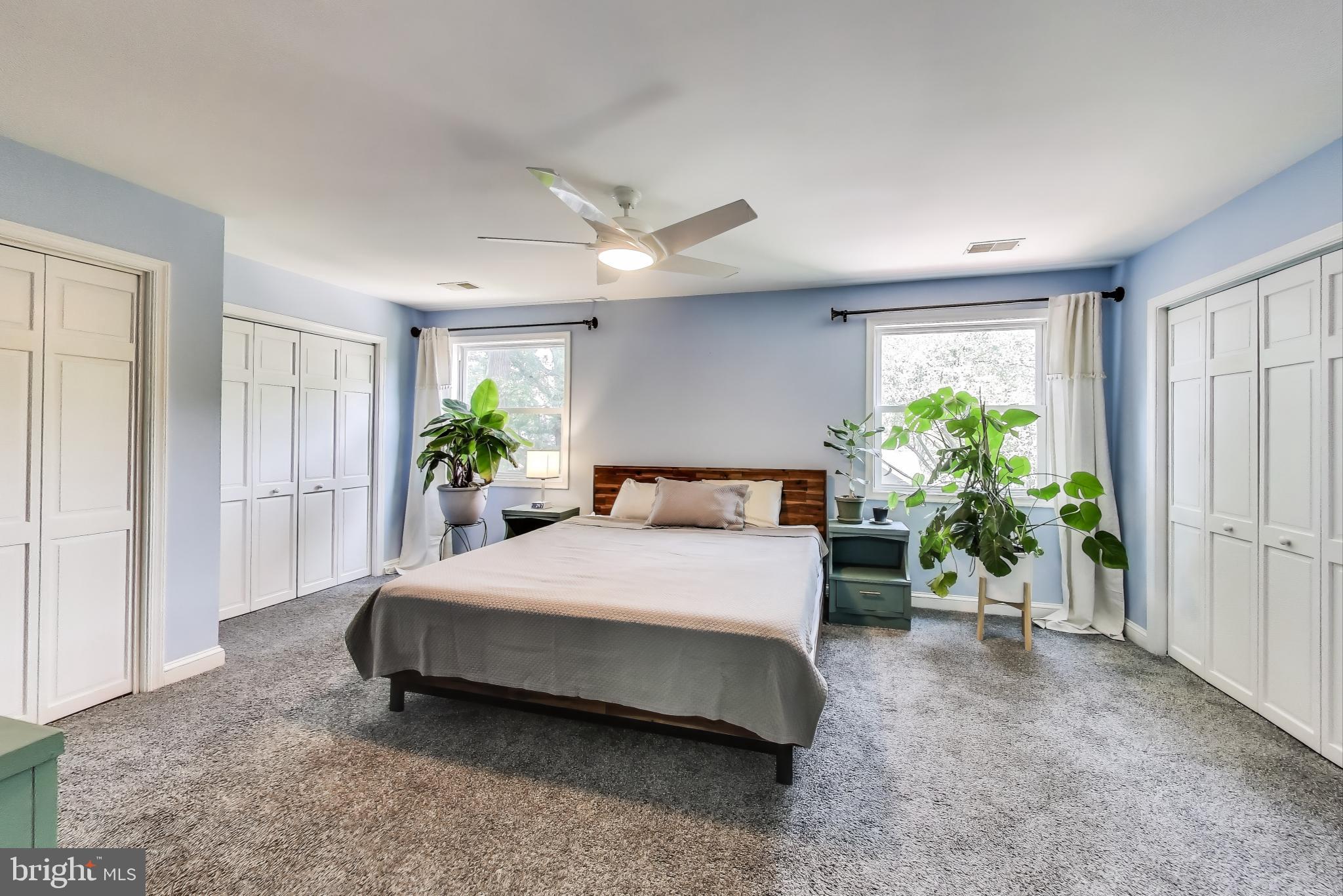 805 Islington Street Silver Spring, MD 20910 - Photo 22 of 50 a spacious bedroom with a bed and a chandelier