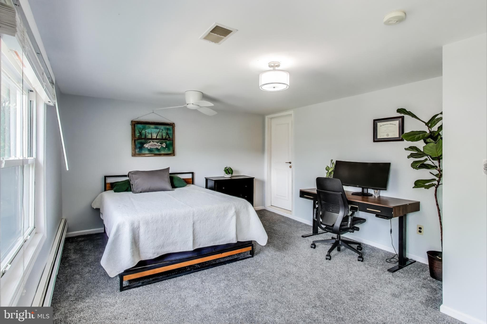 805 Islington Street Silver Spring, MD 20910 - Photo 28 of 50 a bedroom with a bed a desk and chair