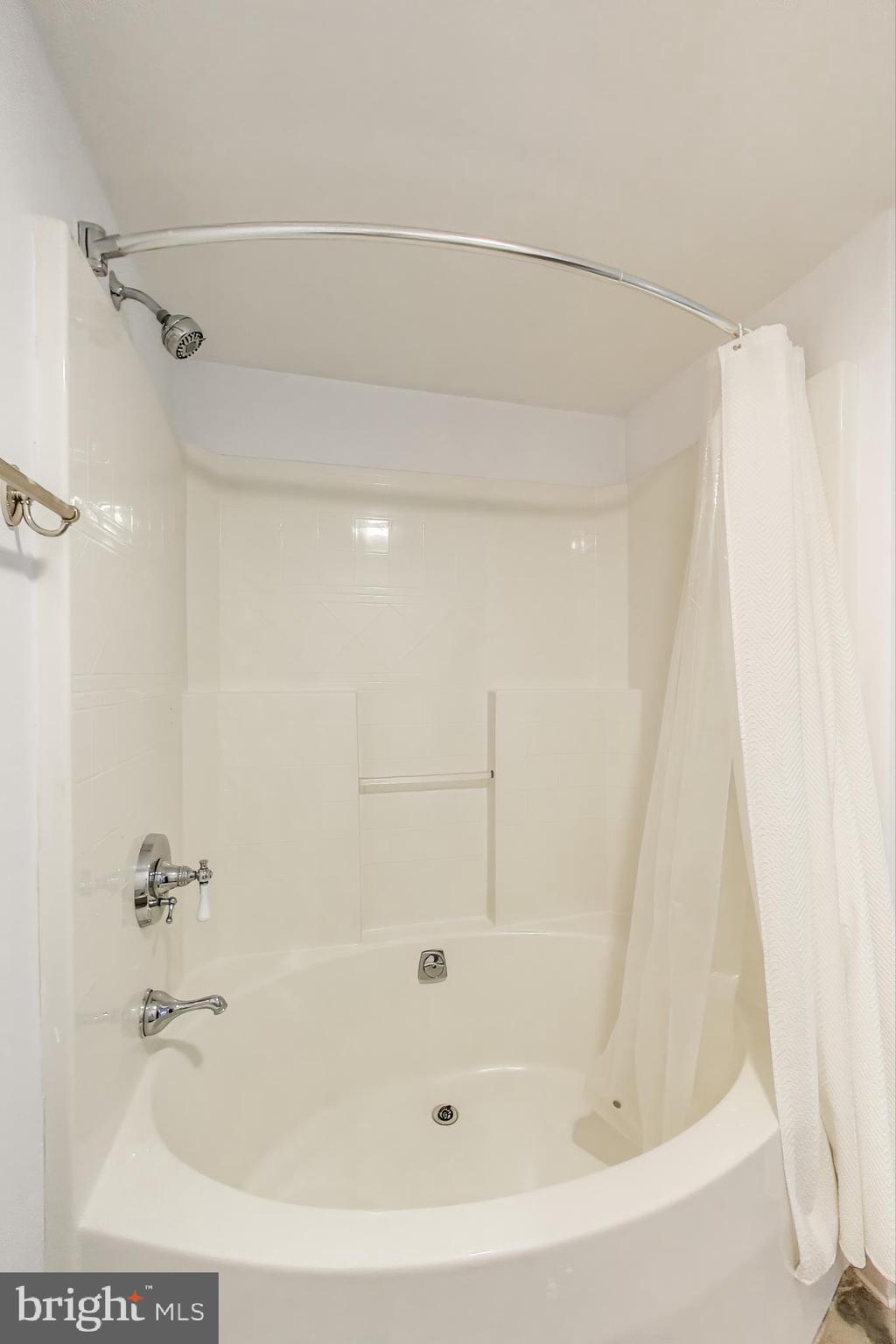 805 Islington Street Silver Spring, MD 20910 - Photo 32 of 50 a white bath tub sitting next to a white sink and vanity