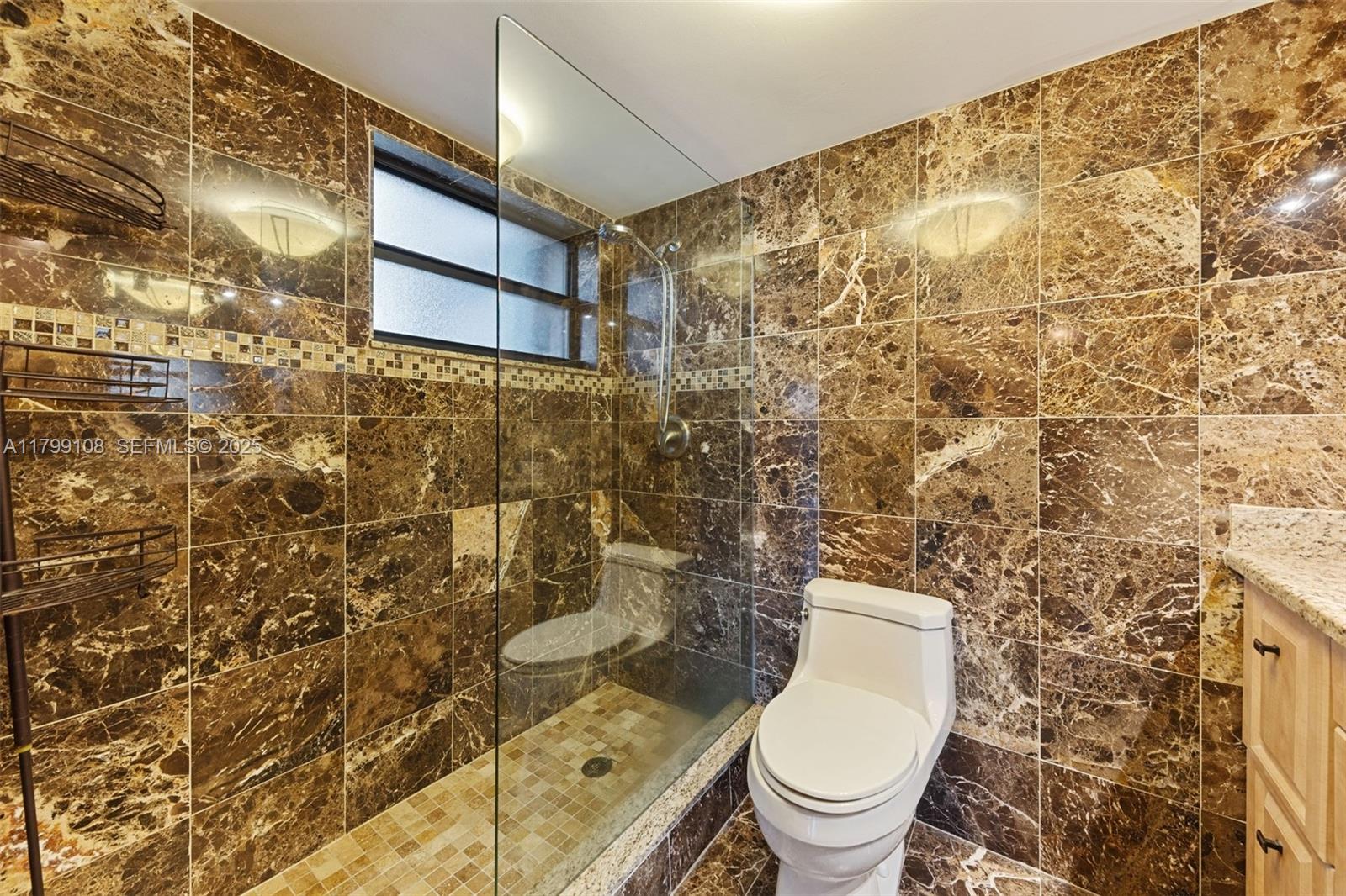 6668 Burning Wood Drive, Unit 166 Boca Raton, FL 33433 - Photo 19 of 27 a bathroom with a toilet and a shower
