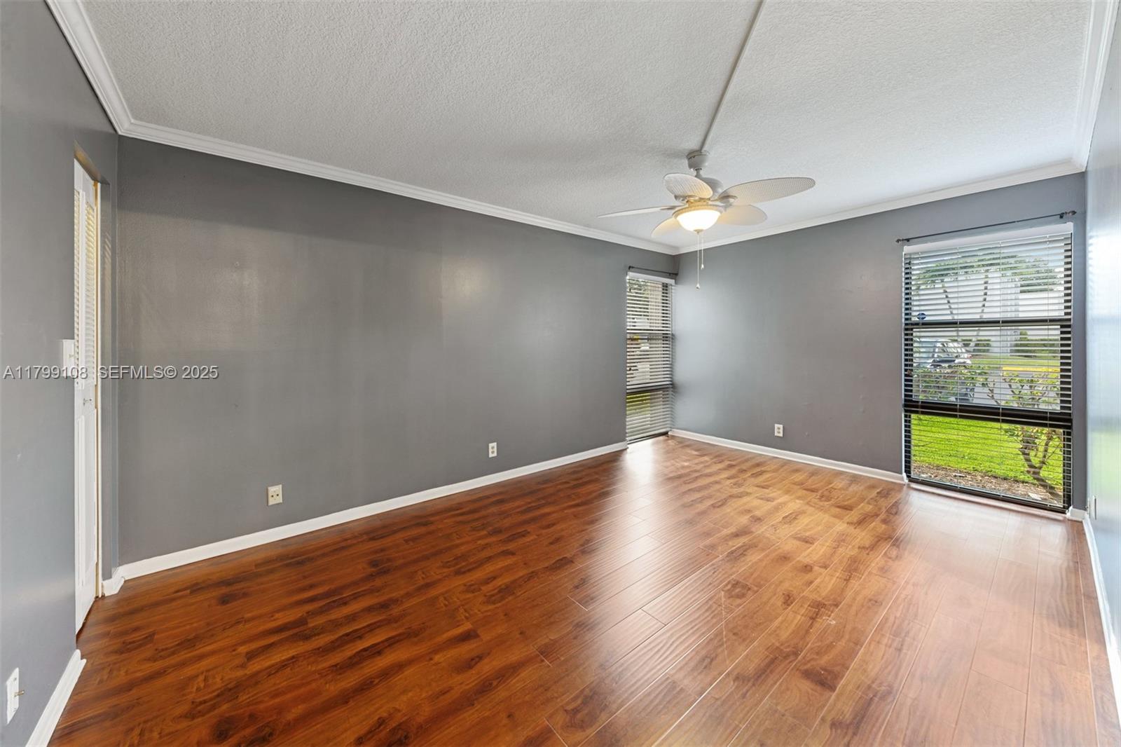 6668 Burning Wood Drive, Unit 166 Boca Raton, FL 33433 - Photo 22 of 27 wooden floor in an empty room with a window