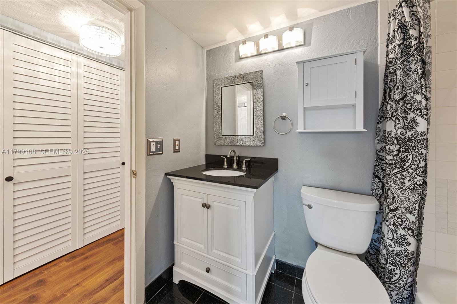 6668 Burning Wood Drive, Unit 166 Boca Raton, FL 33433 - Photo 24 of 27 a bathroom with a toilet a sink and a window