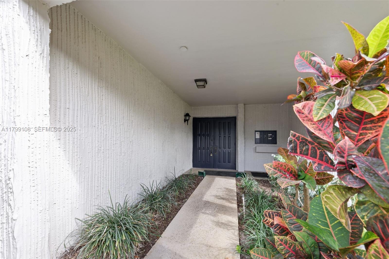 6668 Burning Wood Drive, Unit 166 Boca Raton, FL 33433 - Photo 3 of 27 a view of a entryway with a flower garden