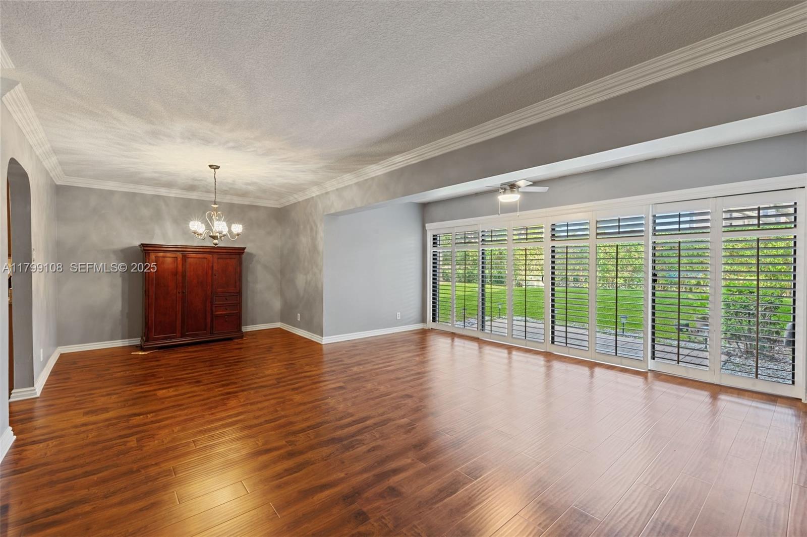 6668 Burning Wood Drive, Unit 166 Boca Raton, FL 33433 - Photo 8 of 27 a view of an empty room with wooden floor and a window