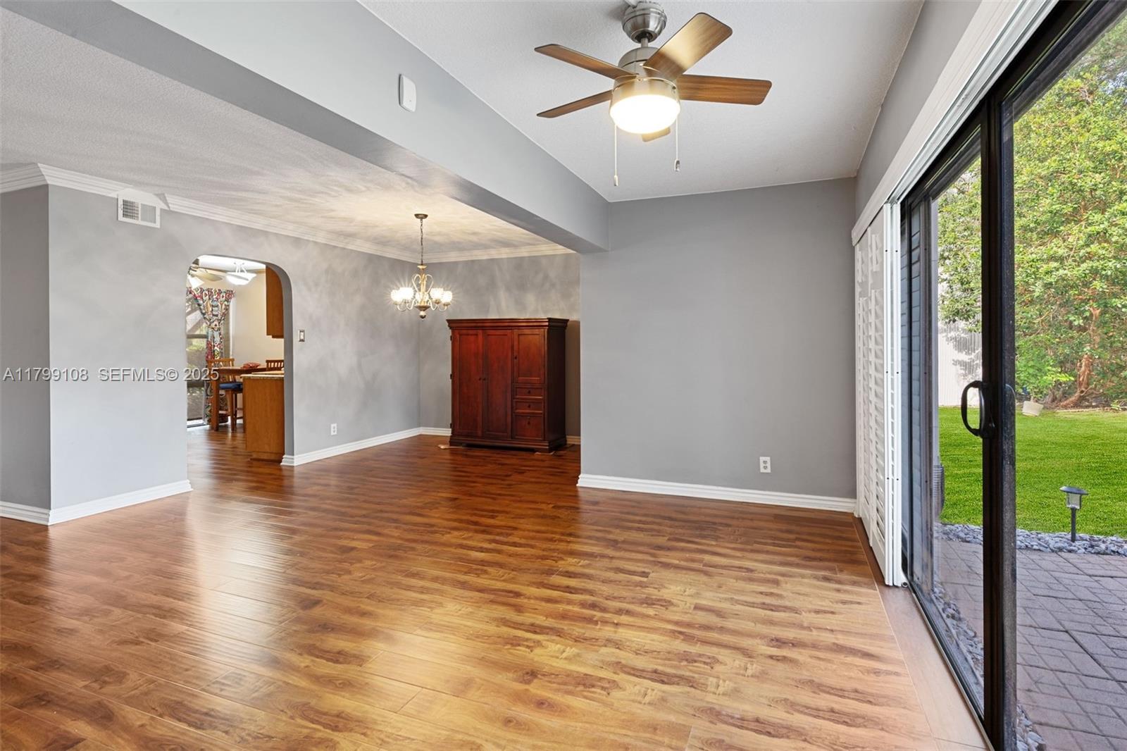 6668 Burning Wood Drive, Unit 166 Boca Raton, FL 33433 - Photo 10 of 27 a view of empty room with wooden floor and fan