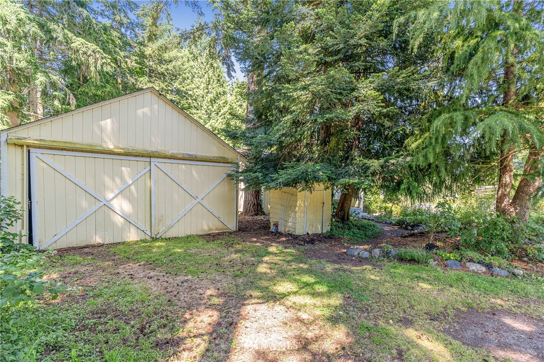 929 Blackburn Road Camano Island, WA 98282 - Photo 12 of 39 a backyard of a house with table and chairs