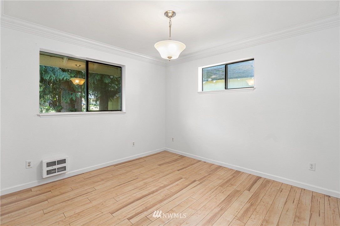 929 Blackburn Road Camano Island, WA 98282 - Photo 14 of 39 a view of empty room with wooden floor and fan