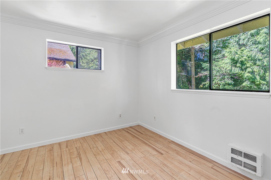 929 Blackburn Road Camano Island, WA 98282 - Photo 21 of 39 wooden floor in an empty room with a window