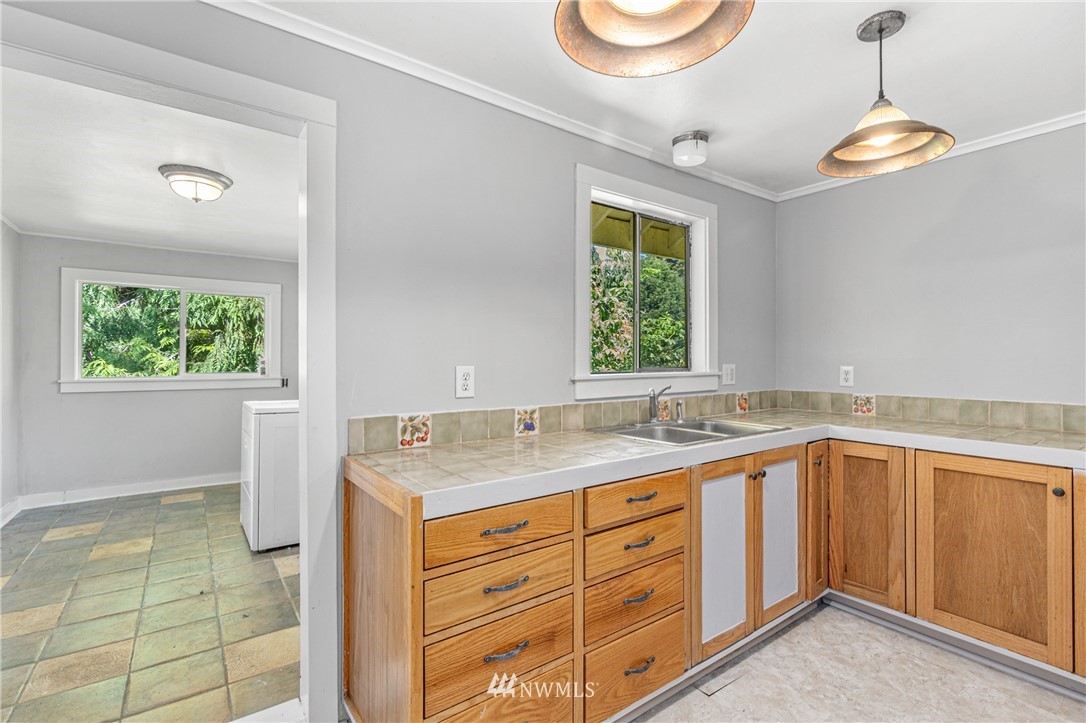929 Blackburn Road Camano Island, WA 98282 - Photo 24 of 39 a bathroom with a granite countertop sink mirror and a window