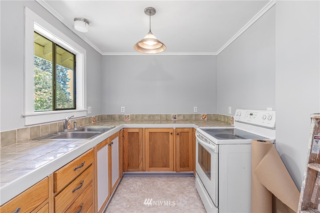 929 Blackburn Road Camano Island, WA 98282 - Photo 25 of 39 a utility room with a sink washer and dryer