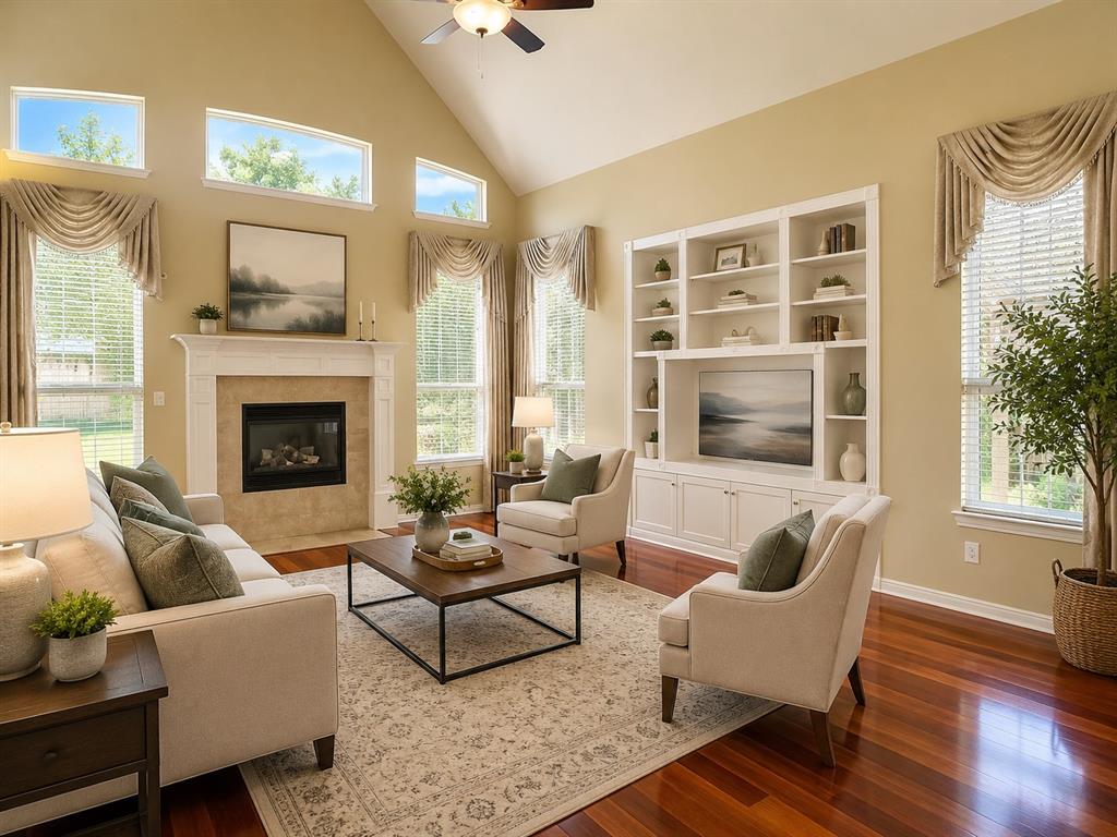 5708 Rickshaw Lane Plano, TX 75094 - Photo 7 of 28 Spacious living area featuring high vaulted ceilings, multiple transom windows, and rich wood-finish flooring