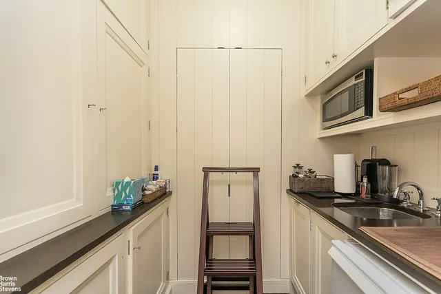 a kitchen with stainless steel appliances granite countertop a sink and a refrigerator