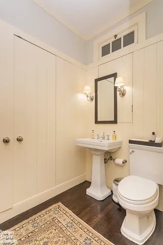a bathroom with a sink a toilet and mirror