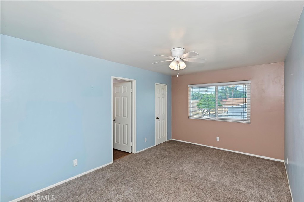 20407 Markham Street Perris, CA 92570 - Photo 13 of 26 an empty room with windows and fan