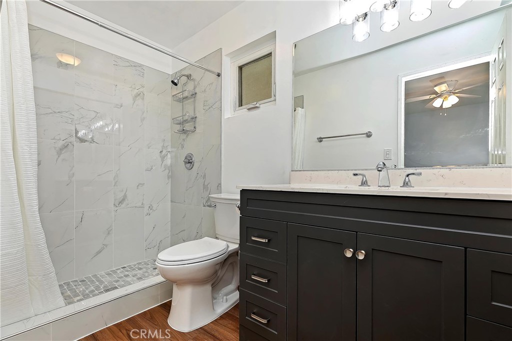 20407 Markham Street Perris, CA 92570 - Photo 14 of 26 a bathroom with a sink a toilet and shower