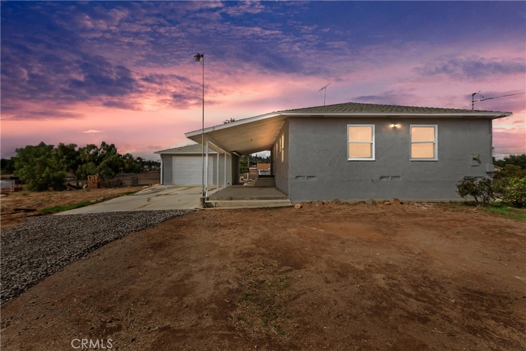 20407 Markham Street Perris, CA 92570 - Photo 2 of 26 a front view of a house with a garden and yard