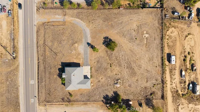 an aerial view of residential house and sandy dunes