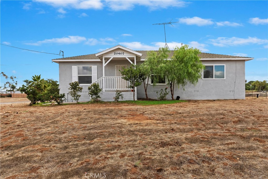 20407 Markham Street Perris, CA 92570 - Photo 5 of 26 a front view of a house with garden