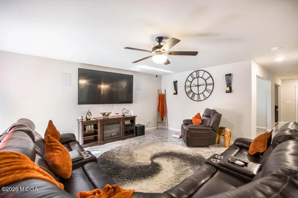 a living room with furniture and a flat screen tv