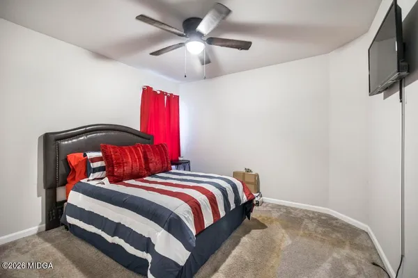 a bedroom with a bed and a flat screen tv
