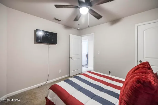 a bedroom with a bed and a flat screen tv