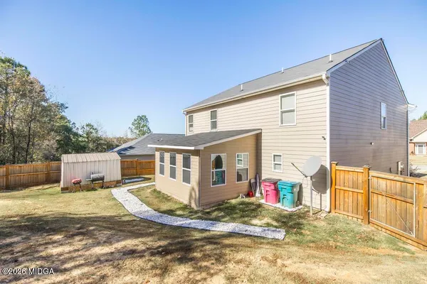 a view of a house with wooden fence