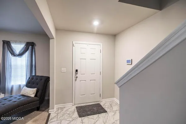 a living room with furniture and a rug