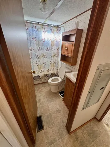 a bath room with a toilet and a shower