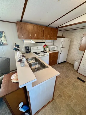 a kitchen with stainless steel appliances a stove a sink a refrigerator and cabinets