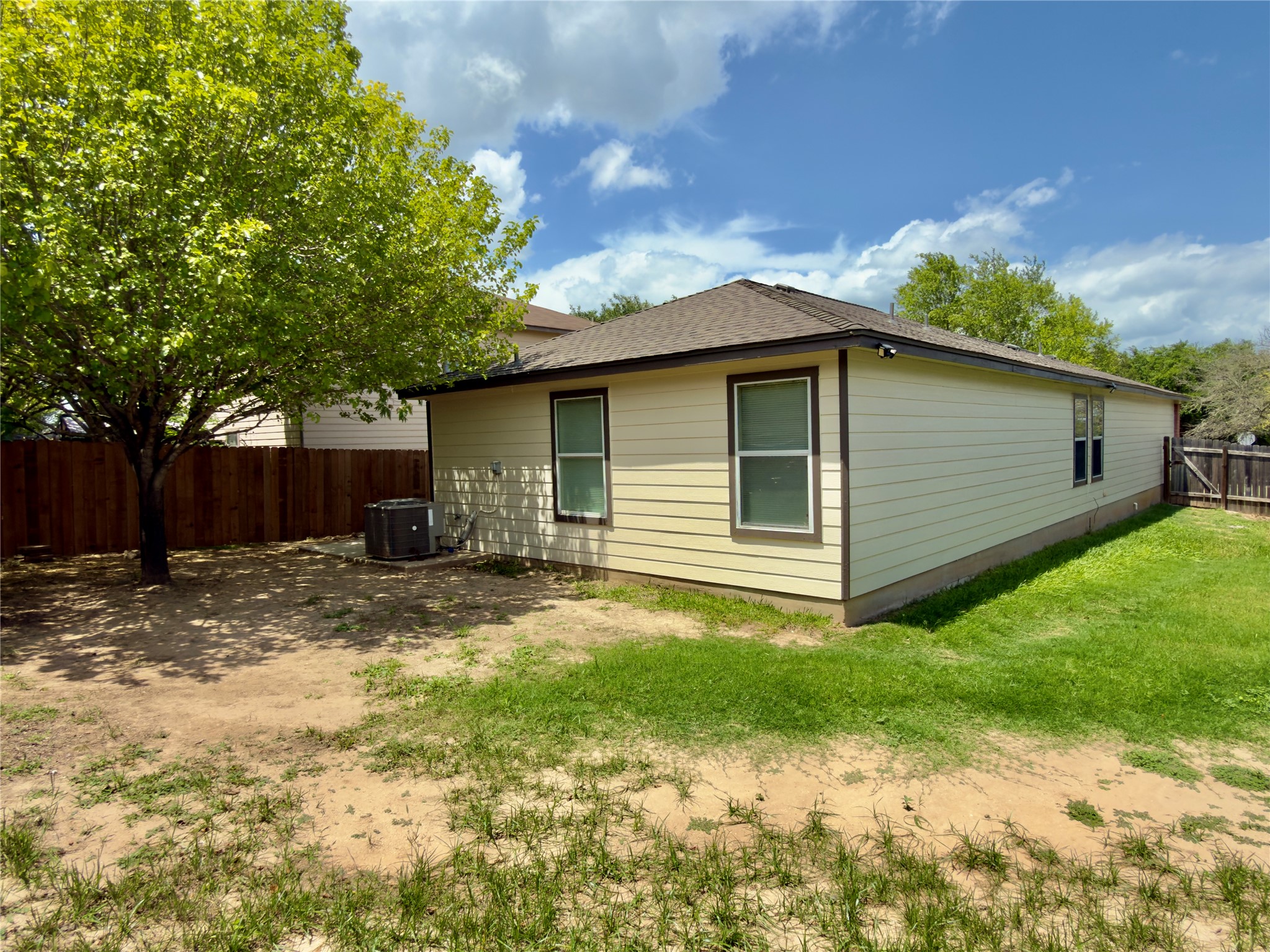 255 Myrtle Street Kyle, TX 78640 - Photo 30 of 31 Exterior siding in a light neutral tone with dark trim