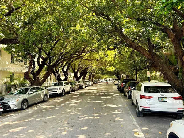 a view of cars parked on the side of a street