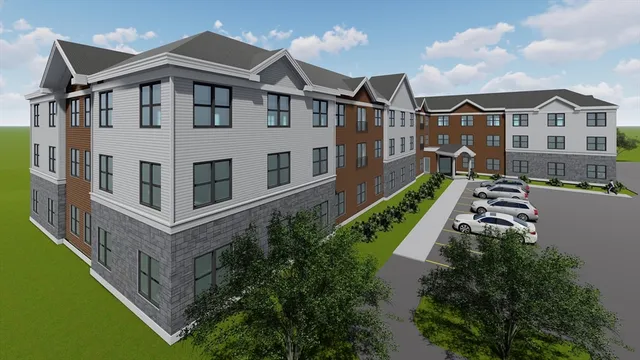 a large white building with a yard in front of it