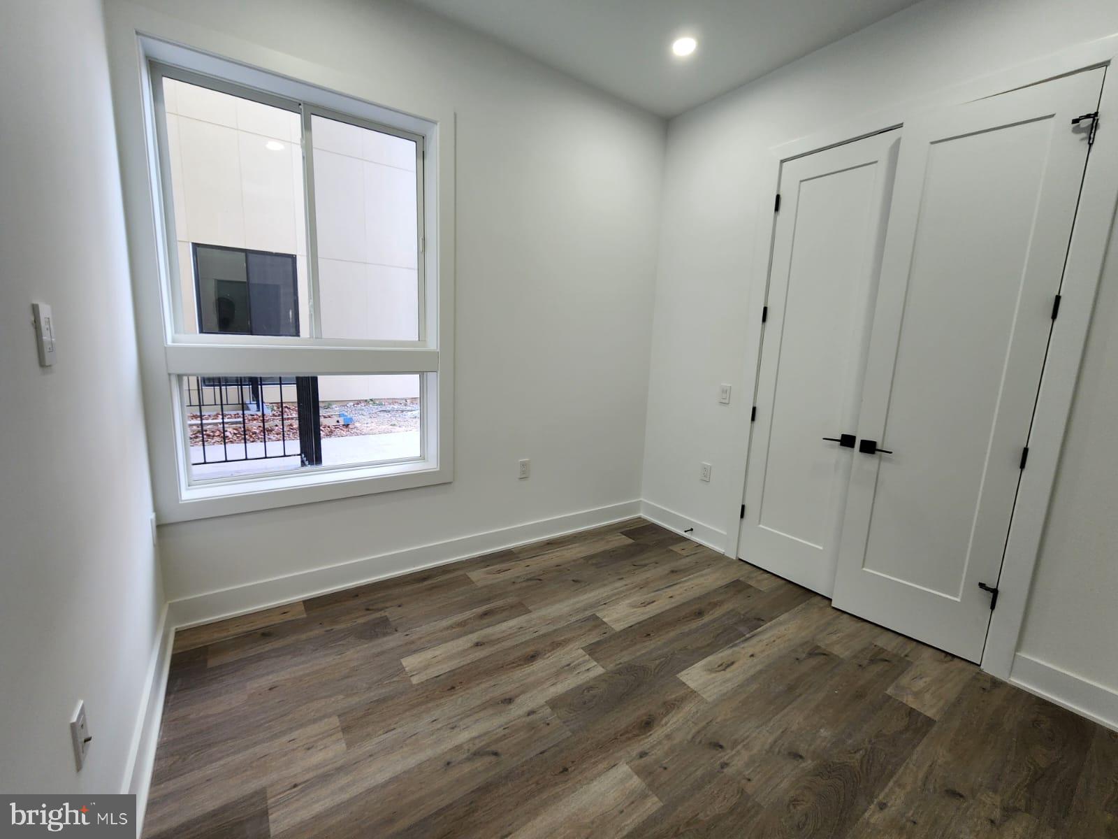 4905 Georgia Avenue Northwest, Unit 105 Washington, DC 20011 - Photo 11 of 18 a view of an empty room with wooden floor and a window
