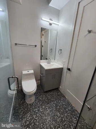 a bathroom with a toilet sink and mirror