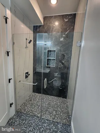 a bathroom with a shower and a sink