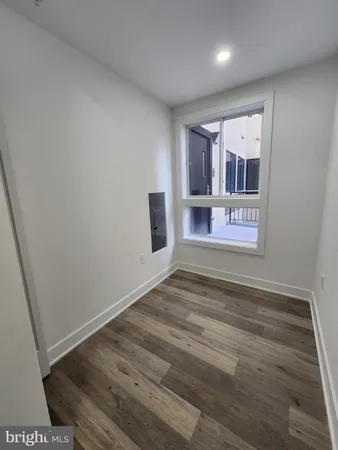 a view of empty room with wooden floor