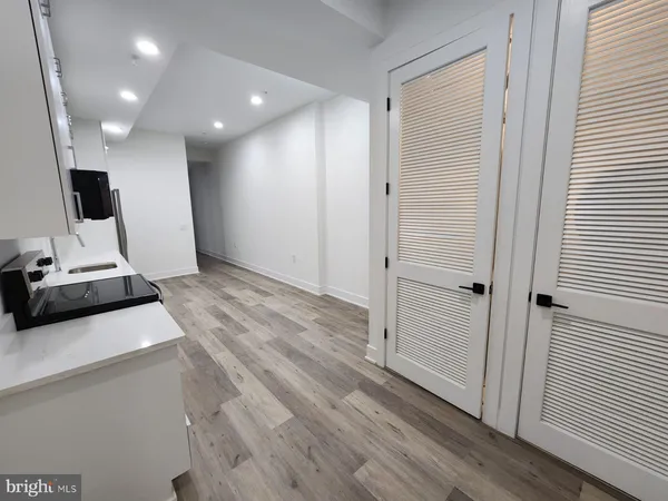 a view of a hallway with a kitchen