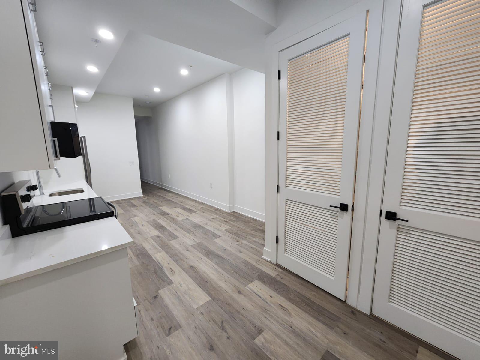 4905 Georgia Avenue Northwest, Unit 105 Washington, DC 20011 - Photo 5 of 18 a view of a hallway with a kitchen