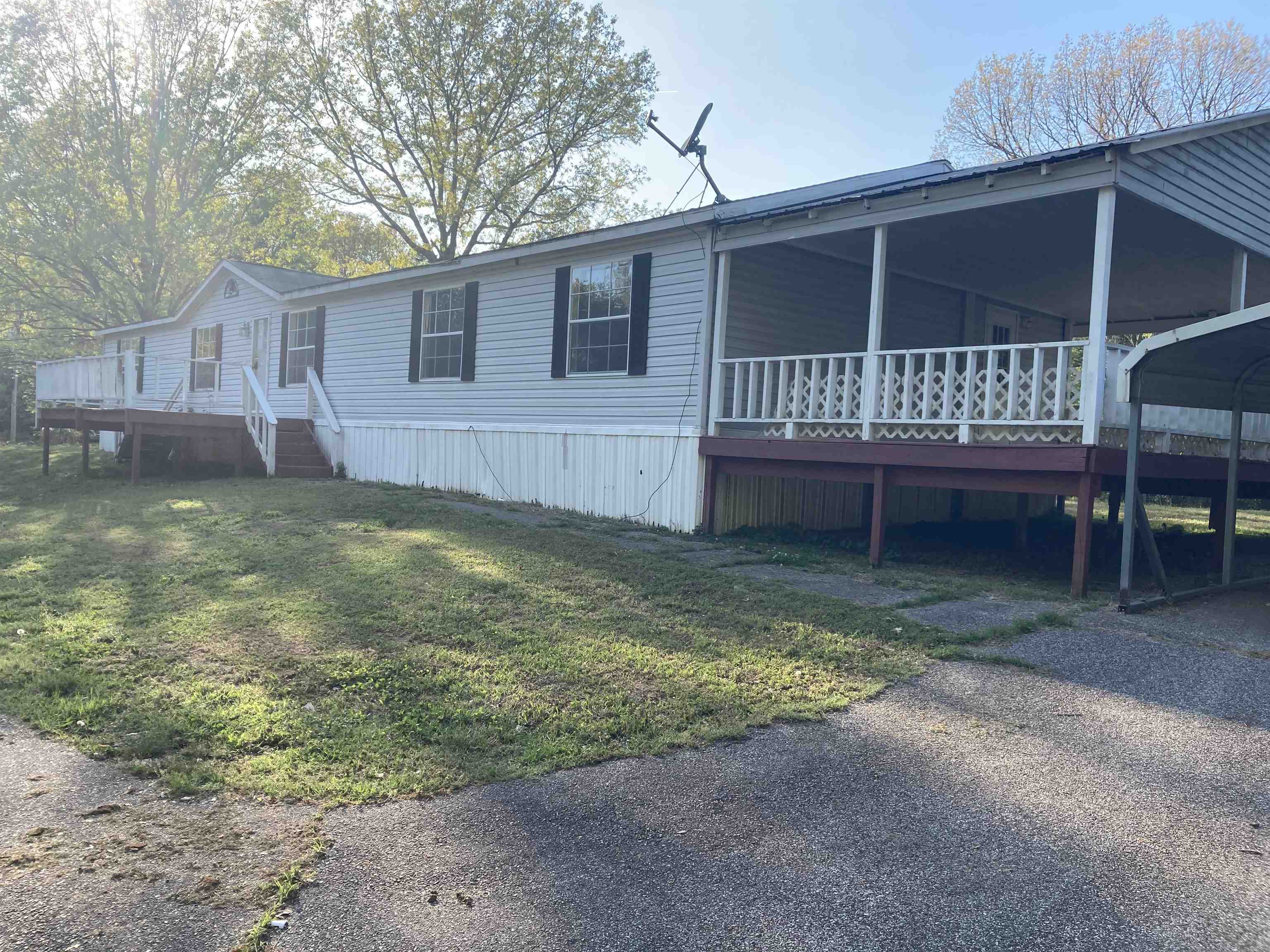 840 Rose Road Somerville, TN 38068 - Photo 1 of 15 Light blue siding exterior with white trim and dark green shutters