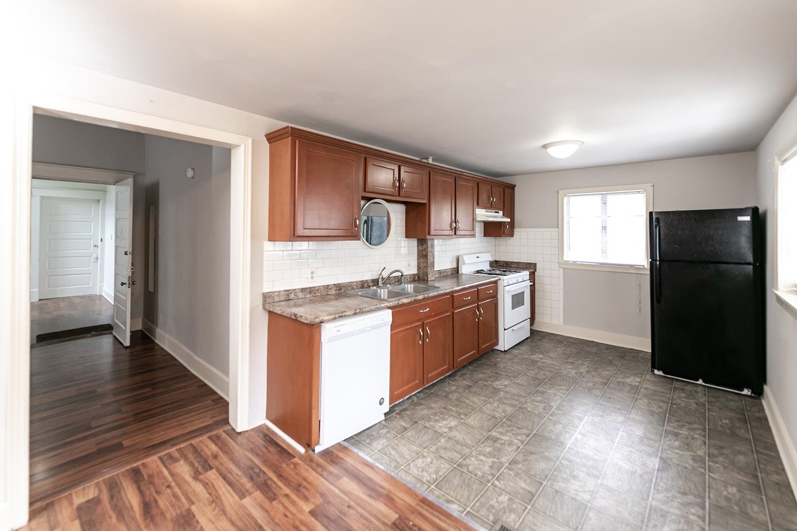 1515 Madison Avenue Memphis, TN 38104 - Photo 11 of 19 a kitchen with a refrigerator and a stove top oven