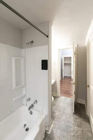 a bathroom with a bathtub and a sink