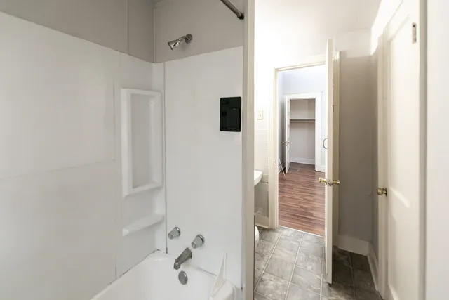 a bathroom with a bathtub and shower