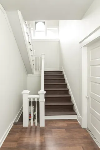 a view of entryway and hall with wooden floor